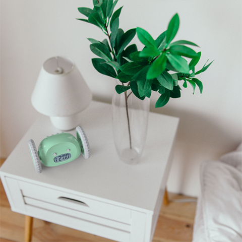 Green clocky on nightstand